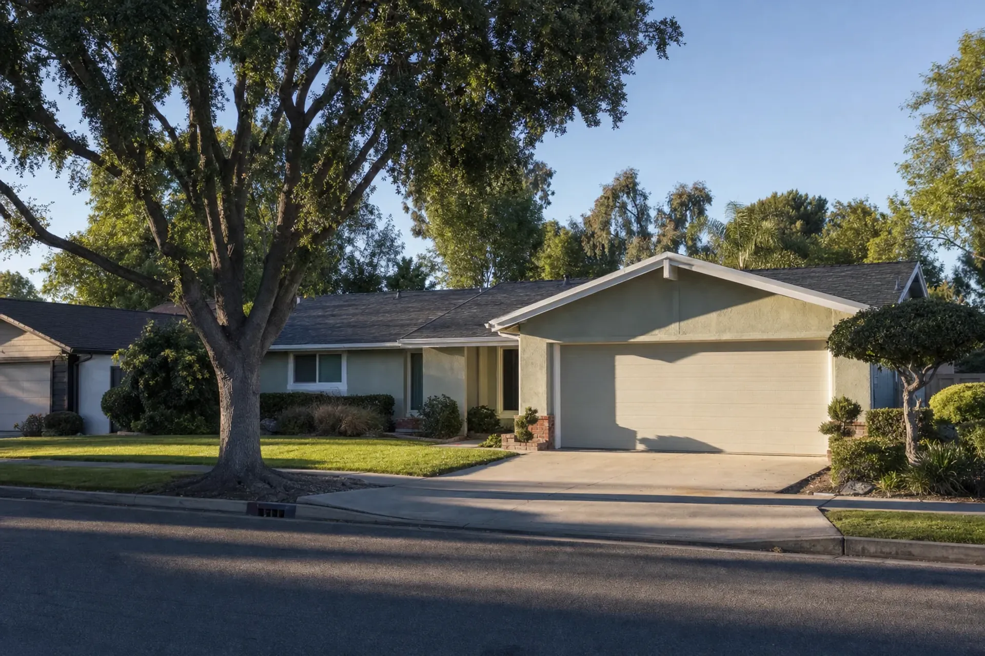 Residential street in Orange County with stucco homes and attached garages, OC Water Heater Pros service area